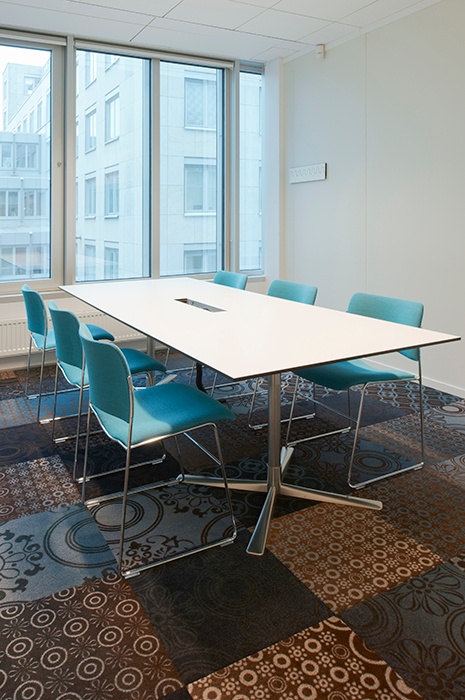 Multi patterned carpet tiles in meeting room Multi patterned carpet tiles in meeting room