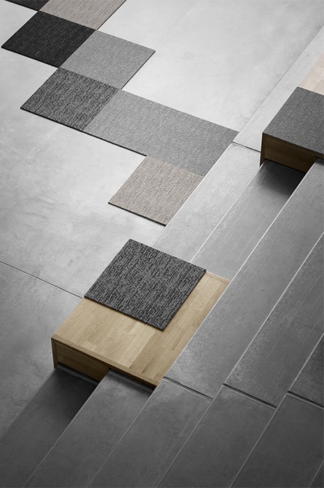 Carpet-tiles-design-laid-out-on-a-plain-concrete-floor