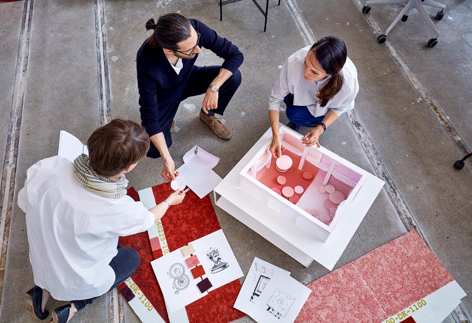 women-and-a-man-planing-a-carpet-design-for-hotels