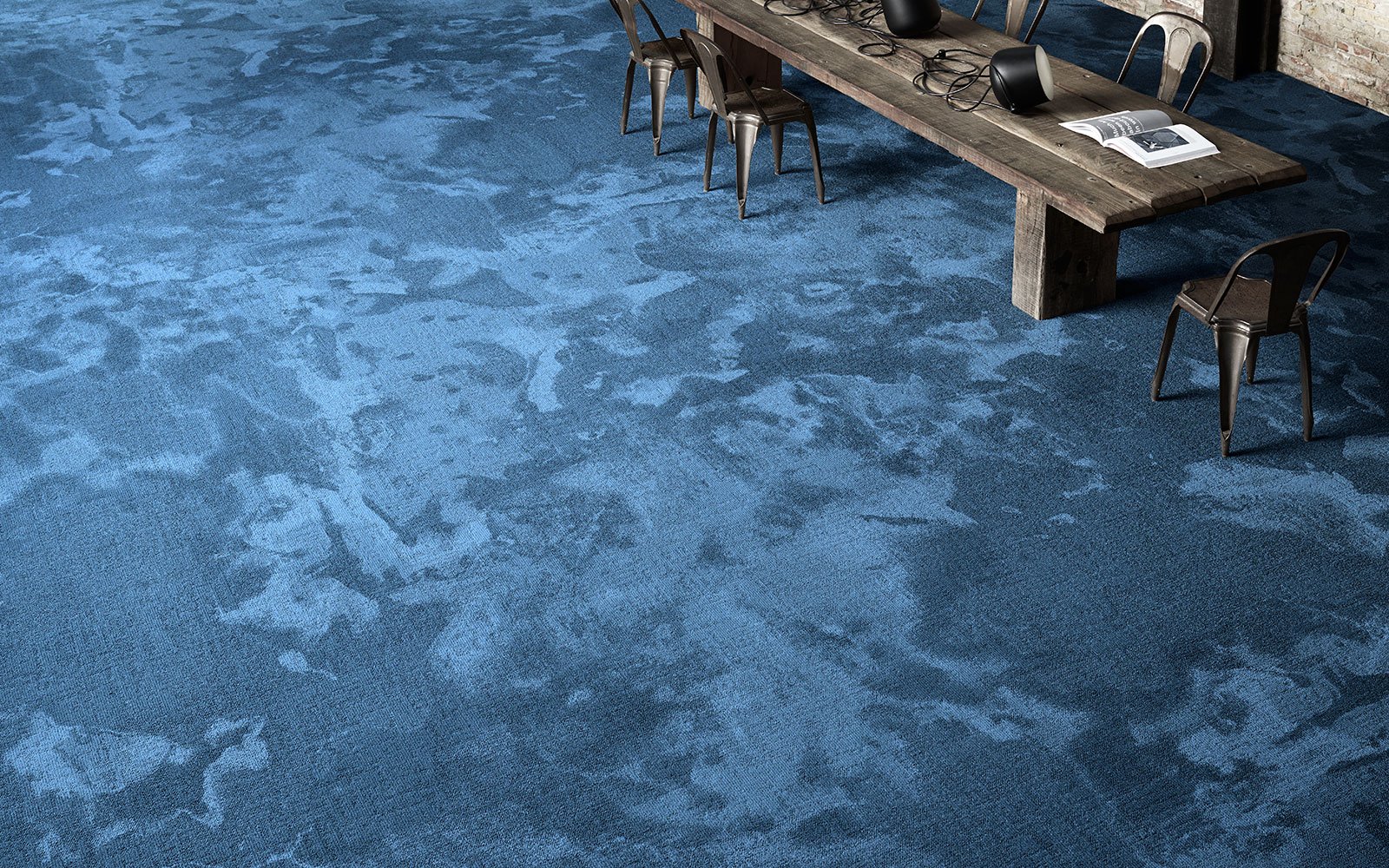 A blue wall-to-wall carpet from the Reform Terra collection by ege